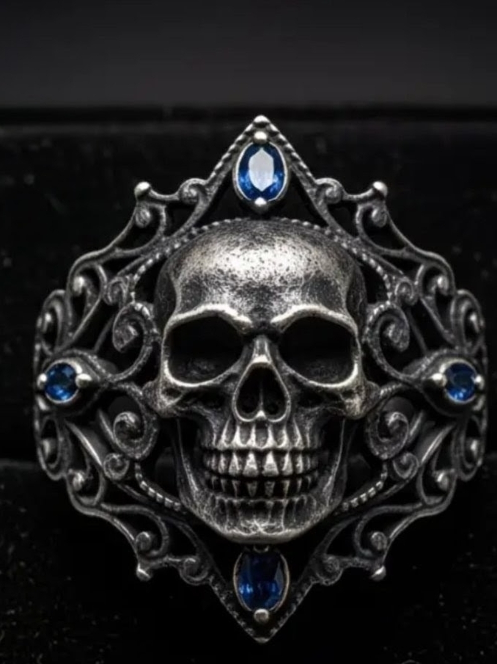Ornate Skull Ring with Blue Gem Accents